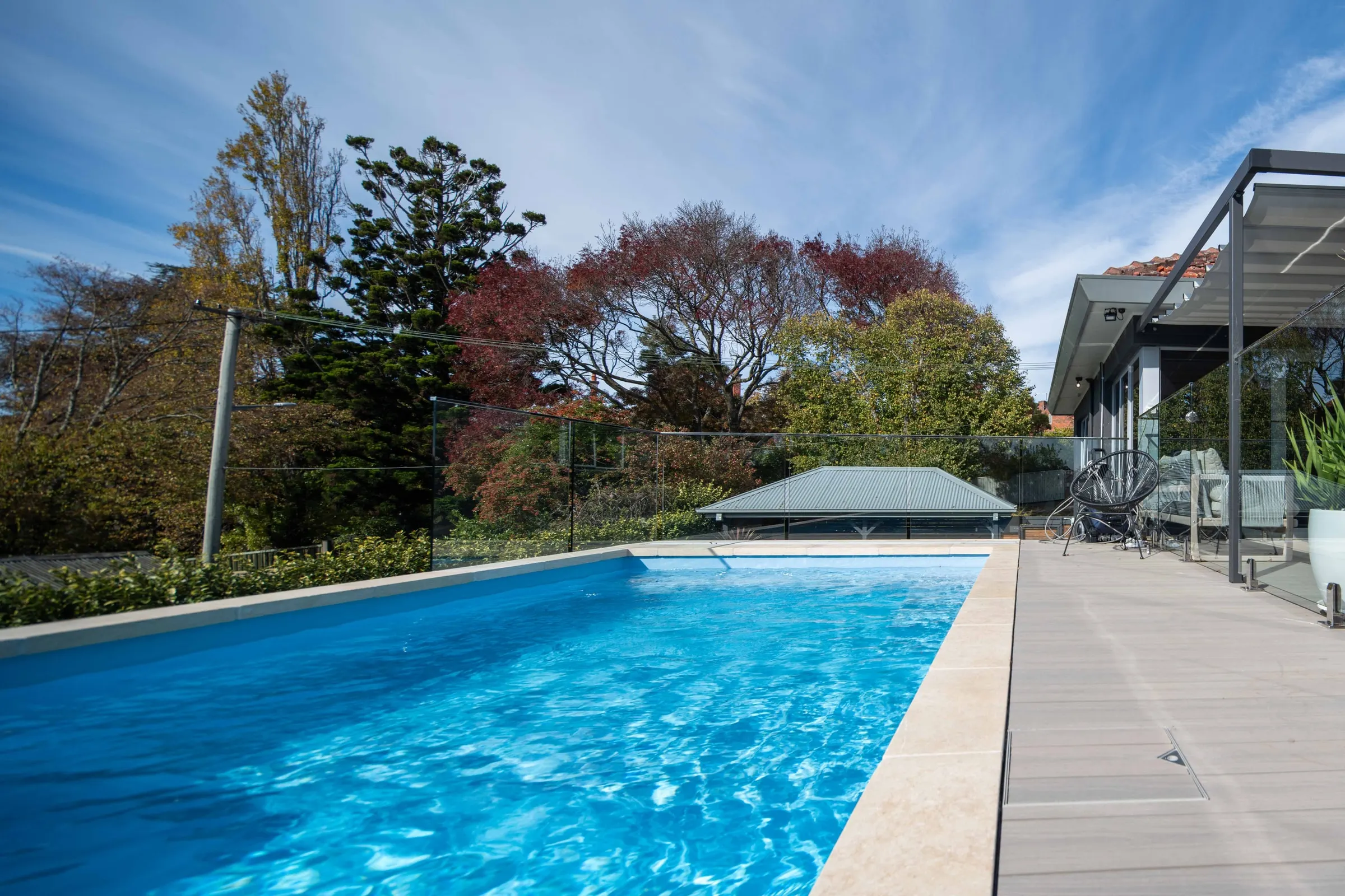 A finished lap pool with a composite deck and a shade structure, East Launceston