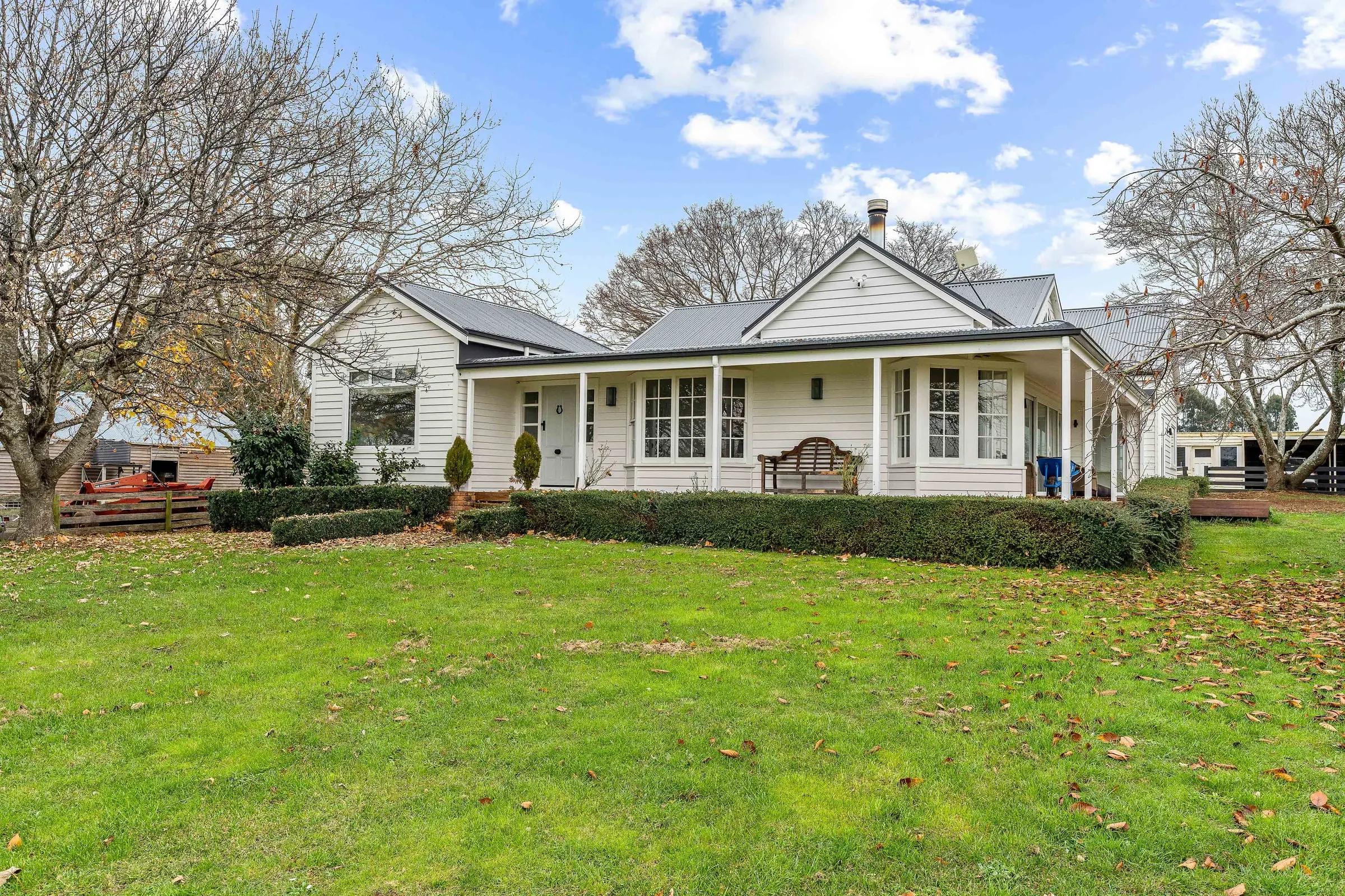 A finished weatherboard house and its garden, Hagley