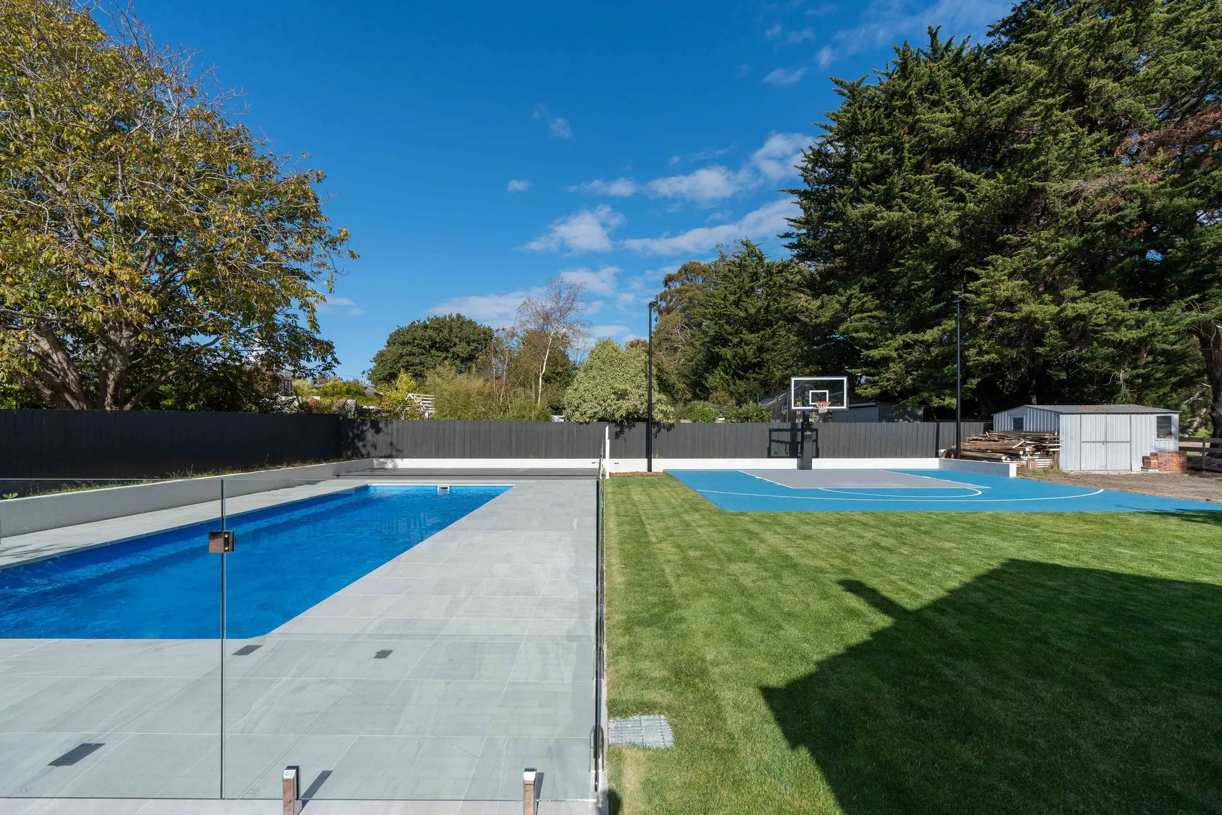 A finished lap pool and basketball court in a garden, Norwood