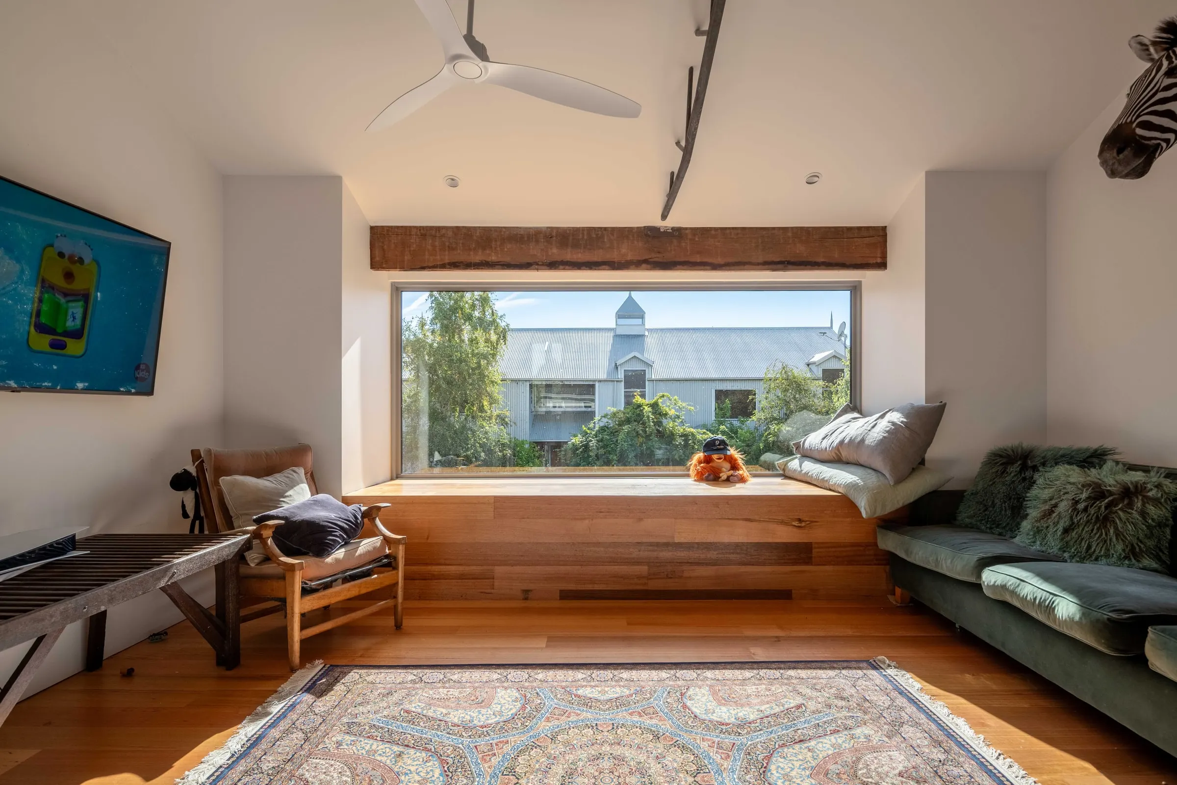 A finished living room with a timber window seat looking out over the valley, Relbia