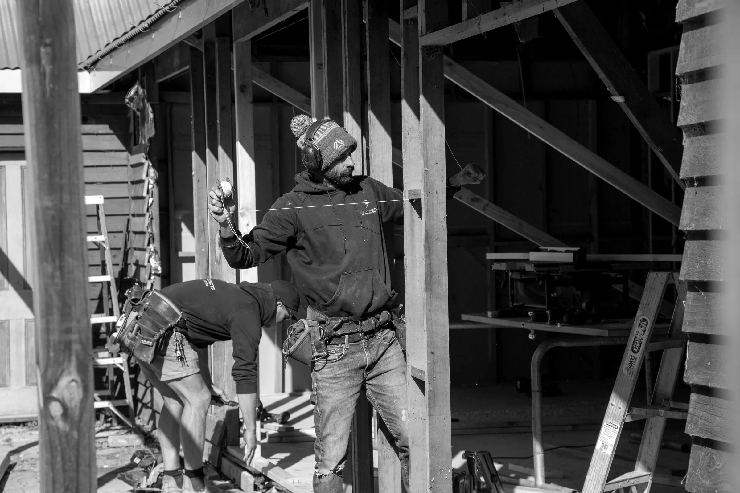Two of the team fixing framing on site at lock up, Relbia